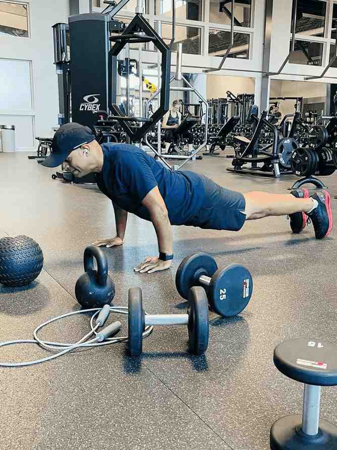 Person doing pushup with weights